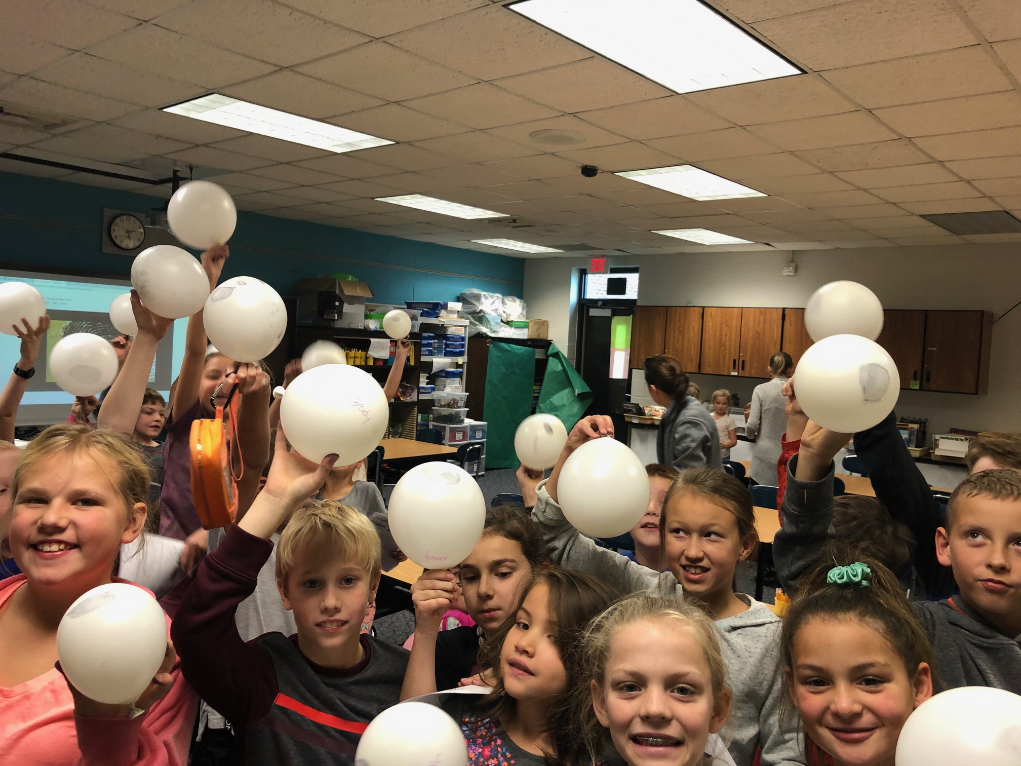 students holding up forensic balloons